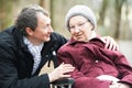 Old senior woman in wheelchair with careful son Royalty Free Stock Photo