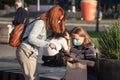 Old senior women wearing a respiratory facemask, confused, trying to understand apps on a smartphone during coronavirus covid 19