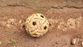 Old sepak takraw ball (Rattan ball) on soil background