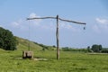 Old serbian sweep well and shadoof on the green meadow Royalty Free Stock Photo