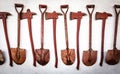 The old set of tools,shovel and ax is hanging on the old white wall Royalty Free Stock Photo