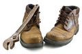 Old, shabby boots and metalwork tool Royalty Free Stock Photo