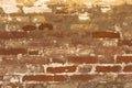 Old shabby damaged plaster on the brick walls of houses close-up