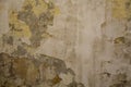 Old shabby gray concrete wall with severe damage and peeling yellow paint. rough surface texture Royalty Free Stock Photo
