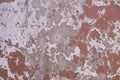 Old shabby gray white concrete wall with peeling red paint. rough surface texture Royalty Free Stock Photo