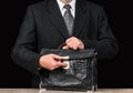 Old shabby leather briefcase in businessmans hand