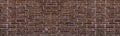 Old shabby red brick wall wide grunge texture. Aged rough brickwork panoramic background Royalty Free Stock Photo