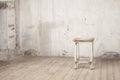 Old shabby stool in an abandoned interior Royalty Free Stock Photo
