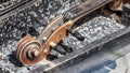 Old shabby vintage violin. Close-up part image with scroll, neck and pegbox Royalty Free Stock Photo