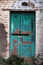 Old shabby wall facade with wooden door. Royalty Free Stock Photo