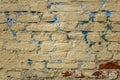 Old shabby white, beige, red brick wall with blue spots of paint closeup. rough surface texture Royalty Free Stock Photo