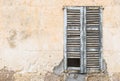 Old shabby wood window shutter with damaged wall background texture Royalty Free Stock Photo