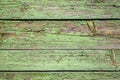 Old shabby wooden background with flaking green paint