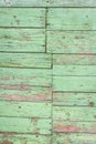 Old shabby wooden background with flaking green paint