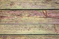 Old shabby wooden background with flaking green paint