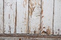 Old shabby wooden planks with cracked white color paint