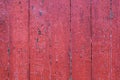 Old shabby wooden planks with red cracked color paint as a background Royalty Free Stock Photo