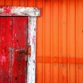 Old shack with red door and orange wall Royalty Free Stock Photo