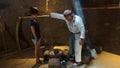 Old shaman healing a young woman in the Ciudad Mitad del Mundo turistic center near of the city of Quito