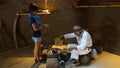 Old shaman healing a young woman in the Ciudad Mitad del Mundo turistic center near of the city of Quito