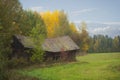 Old shed or barn with sagging roof in autumn landscape