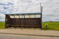 An old  shed at a bus stop on a country road somewhere in Poland Royalty Free Stock Photo