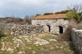 Old shed for sheep made of stone with two entrances Royalty Free Stock Photo