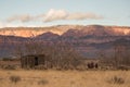 Old shed and tractor sitting among winter bare trees on Smith`s Mesa in Southern Utah. Royalty Free Stock Photo