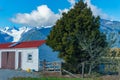 Old shed of wooden construction with red roof and brown doors and one four paned small window Royalty Free Stock Photo