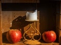 Two red apples and candle