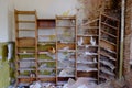 Old shelves for papers in an abandoned room. Rubbish and papers scattered around the room