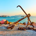 Old ship anchor on pier in port of Aegina