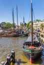 Old ship and church tower in the historic harbor of Gouda Royalty Free Stock Photo