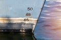 Old ship draft on hull, scale numbering. Distance between waterline and bottom keel Royalty Free Stock Photo