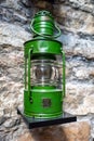 Old ship green lantern hanging on the wall. Royalty Free Stock Photo