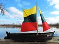 Old ship with lithuanian flag on Rusne island coast, Lithuania