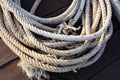 Old ship ropes pile for towing ship on wooden flooring closeup at the port. Royalty Free Stock Photo