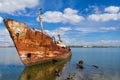 Old ship run aground and rusting in the shore