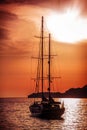 Old ship sailing to the sunset. Royalty Free Stock Photo