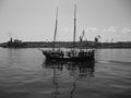 An old ship at sea. Black and white photo. A small corrable in the old style with masts. A small pirate ship. Royalty Free Stock Photo