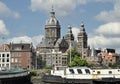 Old ships in Amstel river against old Amsterdam