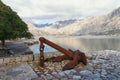 Old ships anchor on the shore of Kotor Bay on a cloudy winter d