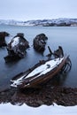 Old ships graveyard at the Barents sea rocky shore. Royalty Free Stock Photo