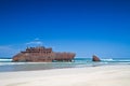 Old shipwreck on sandy beach