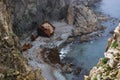 An old shipwrecked ship stands on the shore at the foot of a rocky cliff. Cape Briner. Primorsky Krai. Russia