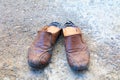 Old shoes leather worn out On floor road background