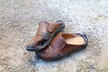 Old shoes leather worn out On floor road background