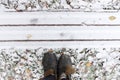 Old shoes on snowy ground in front of straight lines