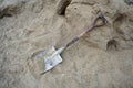 An old shovel is placed on a pile of sand on a construction site. Royalty Free Stock Photo