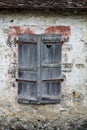 Old shutter window on stone wall Royalty Free Stock Photo